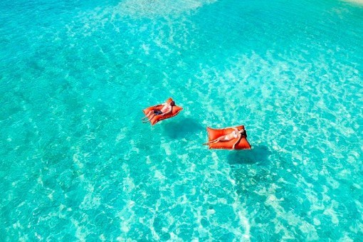 Ontspannen in het kristalheldere water bij Summer Island, de Maldiven
